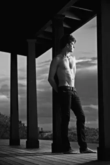 Low angle view of shirtless muscular man in jeans Low angle view of shirtless muscular man in jeans