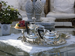 Luxuriously set coffee table with silver coffee and tea pots Luxuriously set coffee table with silver coffee and tea pots