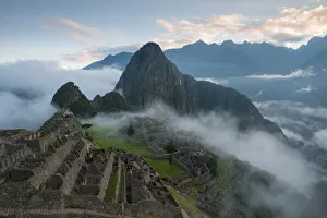 Machu Picchu at Sunrise with rolling fog and clouds Machu Picchu at Sunrise with rolling fog and clouds