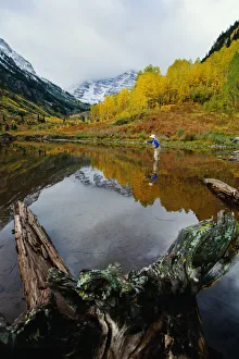 Male Flyfishing below Maroon Bells, Aspen, Colorado Male Flyfishing below Maroon Bells, Aspen, Colorado