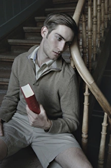 Man with book in a stairwell, nostalgic portrait Man with book in a stairwell, nostalgic portrait