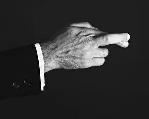 Man crossing fingers in studio, (B&W), close-up Man crossing fingers in studio, (B&W), close-up
