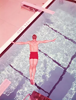 Sports Venue Gallery: Man diving into swimming pool, overhead view. (Photo by H