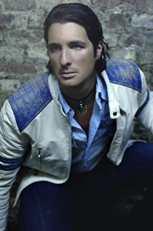 Man, early 30's, wearing a leather jacked in a basement, portrait Man, early 30's, wearing a leather jacked in a basement, portrait