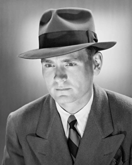 Man in Fedora hat in studio, (B&W), close-up, portrait Man in Fedora hat in studio, (B&W), close-up, portrait