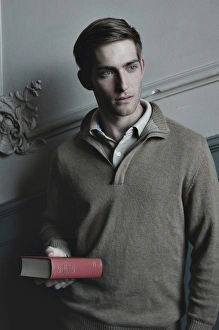 Man holding a book in the stairwell, nostalgic portrait Man holding a book in the stairwell, nostalgic portrait