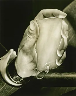Man holding key label, close-up of hand, (B&W) Man holding key label, close-up of hand, (B&W)