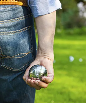 Man playing boules, petanque, preparing to throw, Hesse Germany, Europe Man playing boules, petanque, preparing to throw, Hesse Germany, Europe