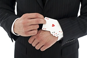 Man wearing a suit pulling several aces out of his sleeve Man wearing a suit pulling several aces out of his sleeve