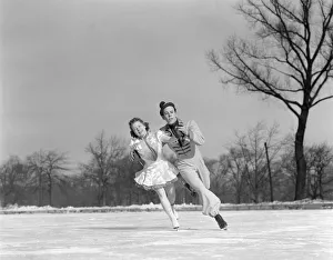 Sports Venue Gallery: Man Woman Couple Pair Figure Skating On Ice Rink Smiling Costumes Arm In Arm Leaning Precision Glide Dance
