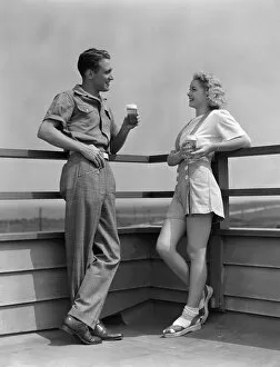 Healthy Eating Gallery: Man and woman smiling at each other, standing outside leaning against railing