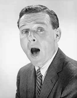 Man yawning, posing in studio, (B&W), portrait Man yawning, posing in studio, (B&W), portrait