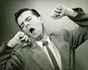 Man yawning and stretching in studio, (B&W) Man yawning and stretching in studio, (B&W)