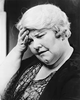 Mature woman suffering headache, (B&W), close-up Mature woman suffering headache, (B&W), close-up
