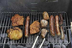 Meat and sausages or bratwursts on a grill, Germany Meat and sausages or bratwursts on a grill, Germany
