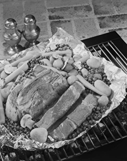 Meat with vegetables in tray on barbecue grill, close-up Meat with vegetables in tray on barbecue grill, close-up