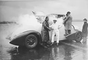 Men standing around liquid oxygen propulsion car (B&W) Men standing around liquid oxygen propulsion car (B&W)