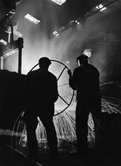 <b class=qtipBold><figcaption>Men At Work In Steel Mill</figcaption></b><br>Three British steelworkers pour molten steel into a mould from a lip ladle which they delicately control with a large wheel, Great Britain, 1930s. (Photo by Herbert/FPG/Getty Images)<br><em>© 2005 Getty Images</em> Men At Work In Steel Mill