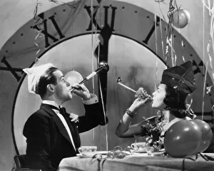 <b class=qtipBold><figcaption>The Midnight Hour</figcaption></b><br>A couple ring in the New Year with party blowers and streamers, circa 1930. (Photo by FPG/Hulton Archive/Getty Images)<br><em>© 2004 Getty Images</em> The Midnight Hour