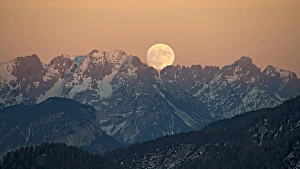 The full moon rising over the Kaiser Mountains, Tyrol, Austria The full moon rising over the Kaiser Mountains, Tyrol, Austria