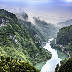 <b class=qtipBold><figcaption>Morning in Wuyang river gorge</figcaption></b><br>Flowing through the Miaoling Mountains, the charming and lively Wuyang River runs 95 kilometers (about 59 miles) from Huangping to Zhenyuan, finally into Yuanjiang River in Hunan Province. Its scenic spots in Zhenyuan, Shibing and Huangping, three counties of Kaili, combine beautifully to form the National Wuyang Scenic Area. Famous for its beautiful landscape, historic sites and dense minority ethnic customs, Wuyang River Scenic Area, covering 625 square kilometers (about 241 square miles), is geographically divided into Upper (Shang) Wuyang between Huangping and Shibing and Down (Xia) Wuyang from Shibing to Zhenyuan. Within these two sections, the most sightworthy and impressive scenery could be enjoyed in Zhenyuan Ancient Town.<br><em>© Copyright 2015 Xiaoyu Yu</em> Morning in Wuyang river gorge