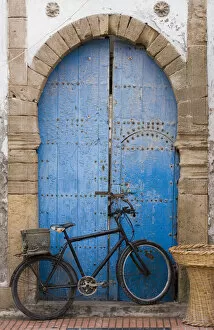 Images Dated 15th April 2006: Morocco, Essaouira, bicycle propped against blue painted door