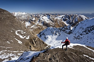 Mountain climber on the summit ridge while descending from Wilde Kreuzspitze Mountain in Mountain climber on the summit ridge while descending from Wilde Kreuzspitze Mountain in