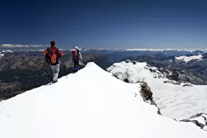 High Mountain Range Gallery: Mountaineer on the summit ridge, descent from Mt Piz Palue, Grisons, Switzerland, Europe