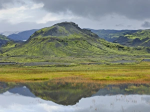 Mountains reflected in a small lake near Soelheimajoekulsvegur, Iceland Mountains reflected in a small lake near Soelheimajoekulsvegur, Iceland