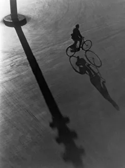 <b class=qtipBold><figcaption>Nighttime Bike Ride</figcaption></b><br>A man cycles across the shadow of a lamppost, circa 1930. (Photo by FPG/Hulton Archive/Getty Images)<br><em>© 2004 Getty Images</em> Nighttime Bike Ride