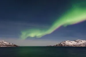 <b class=qtipBold><figcaption>Northern Light Show</figcaption></b><br>Northern Lights (Aurora Borealis) over GrotfjAžrd, KvalAžya (lit. Whale Island). KvalAžya is a montainous island located in Troms county in northern Norway. Moonlit, snowcapped mountains reflected in the water.<br><em>© Krzysztof Baranowski</em> Northern Light Show