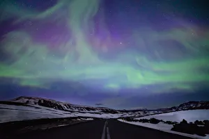 Northern lights over distant mountains in Iceland Northern lights over distant mountains in Iceland