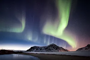 northern lights over a mountain on the beach northern lights over a mountain on the beach