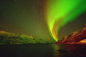 <b class=qtipBold><figcaption>Norwegian Aurora Borealis</figcaption></b><br>A magnetised solar flare illuminates the snow capped mountains of this fjord, In Troms county, Northern Norway<br><em>© Nathanroker 2015</em> Norwegian Aurora Borealis
