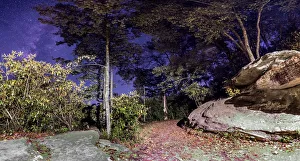 <b class=qtipBold><figcaption>October Blues</figcaption></b><br>The milky way rising above a trail located in the Blue Ridge Mountains with colored leafs all over the ground.<br><em>© ROBERT LOE</em> October Blues