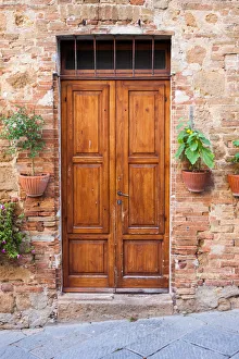 Old elegant wooden door in italian village Old elegant wooden door in italian village