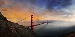 Panoramic view of the Golden Gate Bridge with a rainbow at sunset and orange-glowing storm clouds Panoramic view of the Golden Gate Bridge with a rainbow at sunset and orange-glowing storm clouds