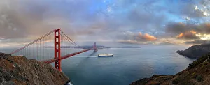 Panoramic view of the Golden Gate Bridge at sunset with a rainbow and storm clouds, San Francisco, California Panoramic view of the Golden Gate Bridge at sunset with a rainbow and storm clouds, San Francisco, California
