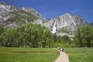 People Walking on Boardwalk Near Yosemite Waterfall People Walking on Boardwalk Near Yosemite Waterfall
