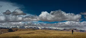 Photographer shooting with Himalayas background Photographer shooting with Himalayas background