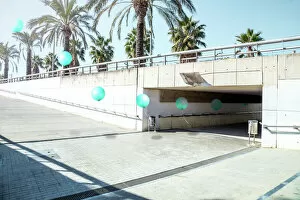Fine Art Photography Gallery: Poetic stop motion picture of green balloons following each other going out from tunnel in a minimal
