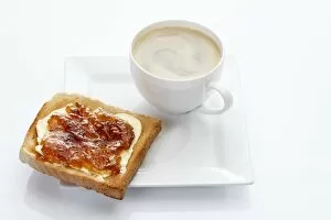 Images Dated 24th December 2011: Porcelain plate with a cup of coffee and toast with apricot jam