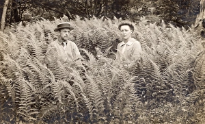 Portrait of a Serious Looking Couple Sitting in Fern Portrait of a Serious Looking Couple Sitting in Fern