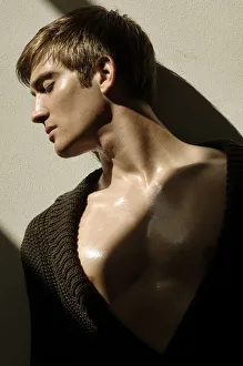 Portrait of a young man leaning on a wall in the sunlight Portrait of a young man leaning on a wall in the sunlight