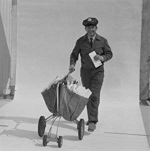 Postal worker carrying letters on wheel barrow against white background, portrait Postal worker carrying letters on wheel barrow against white background, portrait