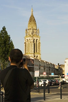 Rear view of a man photographing a church, Leglise Sainte-Marie De La Bastide, Bordeaux Rear view of a man photographing a church, Leglise Sainte-Marie De La Bastide, Bordeaux