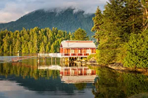 Red dock house with pier over the harbour water in Tofino, Vancouver Island, Canada Red dock house with pier over the harbour water in Tofino, Vancouver Island, Canada