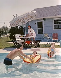 Inflatable Gallery: Retro Family In Backyard, Showing An In-Ground Swimming Pool, Father, Mother, Son