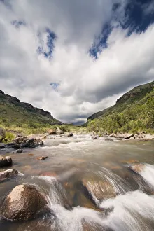 River landscape in Drakensberg with dramatic clouds and mountain River landscape in Drakensberg with dramatic clouds and mountain
