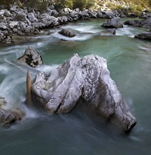 Rock in the turquoise Soca river, Soca Valley near Bovec, Triglav National Park, Slovenia Rock in the turquoise Soca river, Soca Valley near Bovec, Triglav National Park, Slovenia